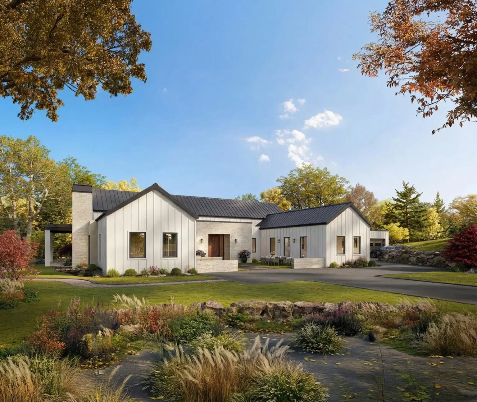 Row of modern white townhomes with metal roofs, landscaped yards, and fall foliage under a blue sky.